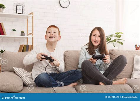 Friendly Brother and Sister Playing Video Games Together Stock Photo - Image of game, friends ...