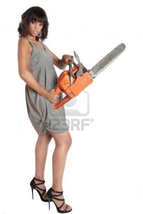 A Brunette Is Dressed To Kill And She Is Holding A Chainsaw To Chainsaw Brunette Dressed