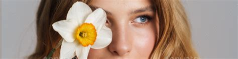 Half Naked Blonde Woman Looking Aside While Posing With Daffodil Stock