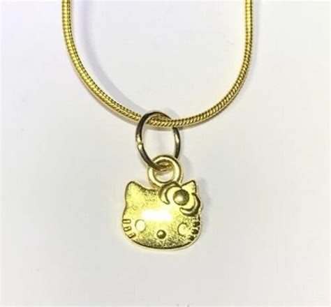 Small Gold Hello Kitty Charm Pendant On A Gold Snake Necklace Chain