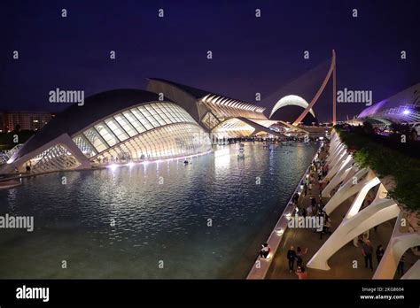 A night view of the city of Valencia with a water canal and modern ...