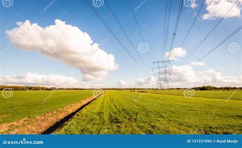 High Voltage Lines And Power Pylons In A Dutch Agricultural Land Stock