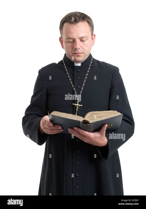 Catholic priest reading the Holy Bible shot on white Stock Photo - Alamy