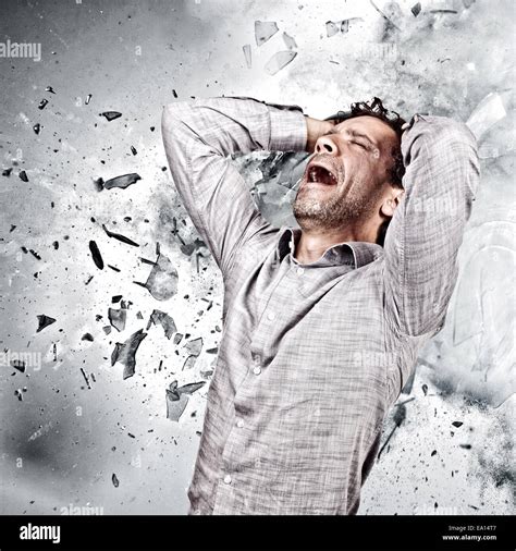 stressed man and background explosion Stock Photo - Alamy