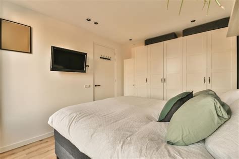 Premium Photo A Bedroom With A Large Bed And White Closets