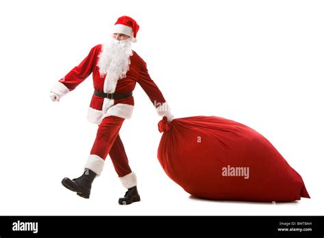 Portrait Of Santa Claus Carrying Heavy Sack With Presents Stock Photo