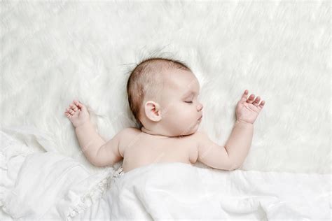 Premium Photo Cute Baby Sleeping On A White Fluffy Background