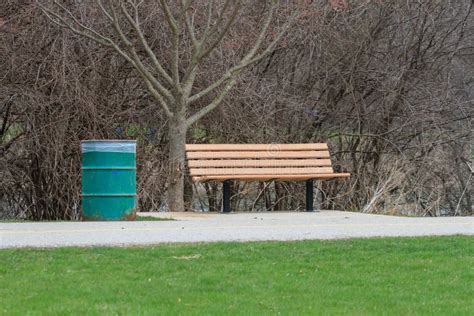 An Empty Park Bench in a City Park. Stock Photo - Image of empty, busy ...