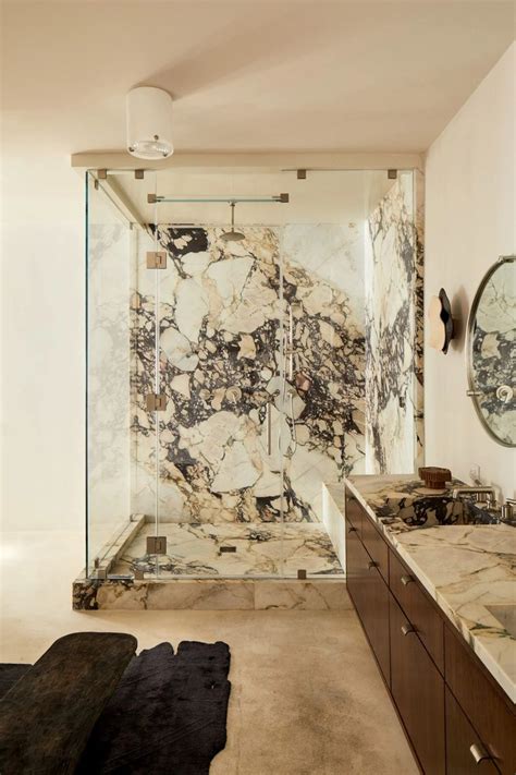 A Large Bathroom With Marble Walls And Flooring