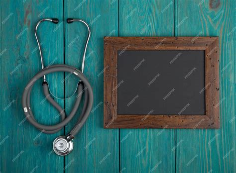 Premium Photo Blank Blackboard And Stethoscope On Wooden Background