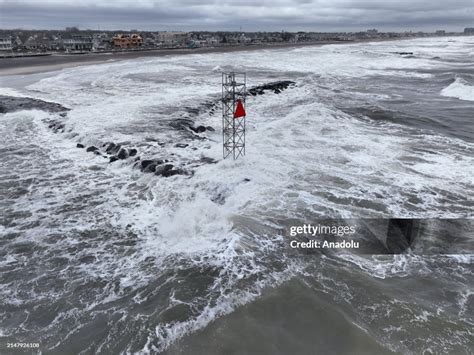 High Winds And Rain Effects Can Be Seen As Waves Crash Into Shore On