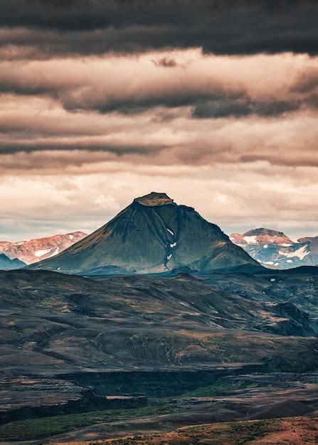 Montaña volcánica en campo de lava y cielo nublado en las tierras altas