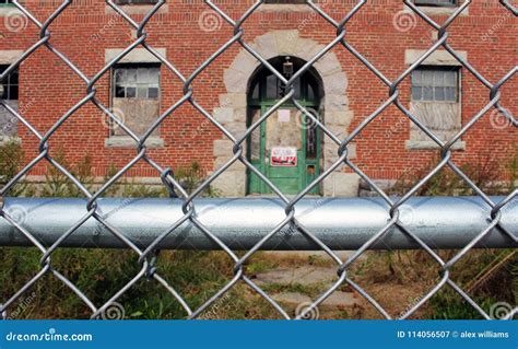 Exterior Of Boarded Up And Abandoned Brick Asylum Hospital Building