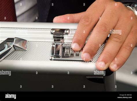 Business Man Unlocking A Combination Lock A Of A Briefcase Stock Photo