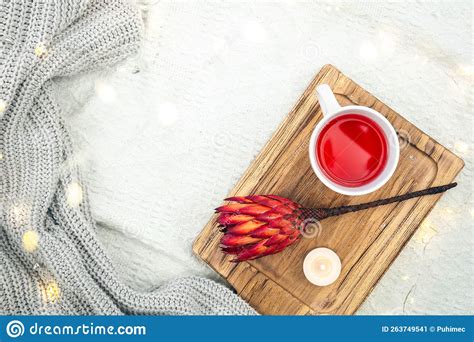 A Cup Of Red Tea And A Flower On A Wooden Tray In Bed Top View Stock