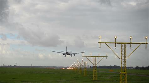 Airplane landing on illuminated runway at early morning. 28033284 Stock ...