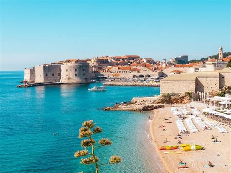 Premium Photo | A beach in dubrovnik, croatia with a boat in the water