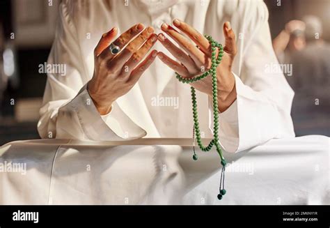 Hands, prayer beads and muslim man praying in mosque, temple or church ...