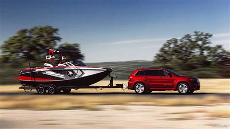 2014 Jeep Grand Cherokee SRT Towing a Boat - Side | Caricos