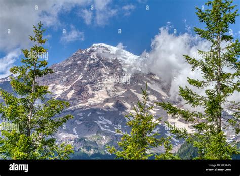 The Majestic And Imposing Summit Of Mt Rainier Draped In Clouds Mt