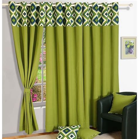 A Living Room With Green Curtains And Pillows