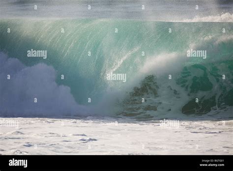 A Large Wave Breaks At Waimea Bay North Shore Oahu Hawaii Stock