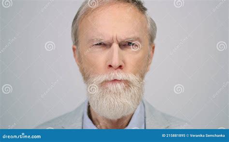 Serious Man Squinting Eyes In Studio Senior Gentleman Looking Camera