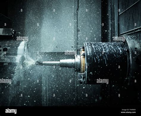 Cnc Machine Drilling With Coolant Stock Photo Alamy