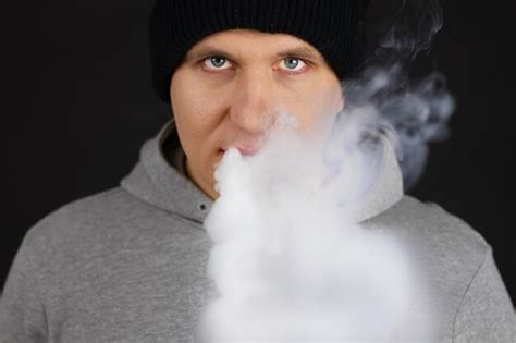 Premium Photo The Man Smoke An Electronic Cigarette On The Dark