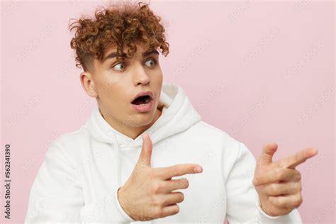 A Funny Shocked Man Stands On A Pink Background In A White Hoodie And