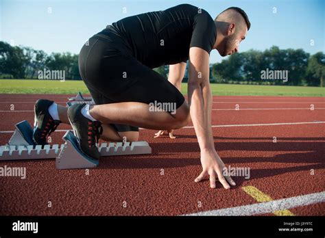 Runners Preparing For Race At Starting Blocks Stock Photo Alamy