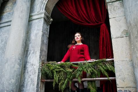 Premium Photo Brunette Plus Size Model At Red Against Arch With Curtains