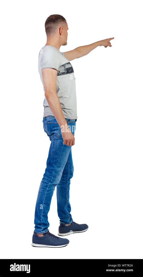 Back View Of A Man In Jeans Points His Hand Upwards Rear View People