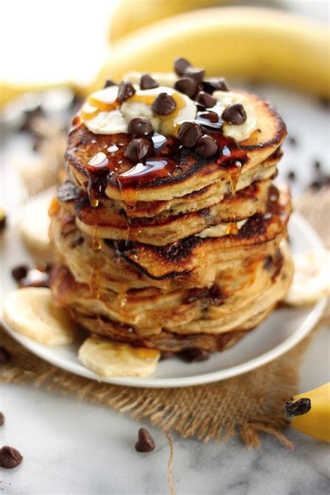 A Stack Of Pancakes Topped With Chocolate Chips And Bananas