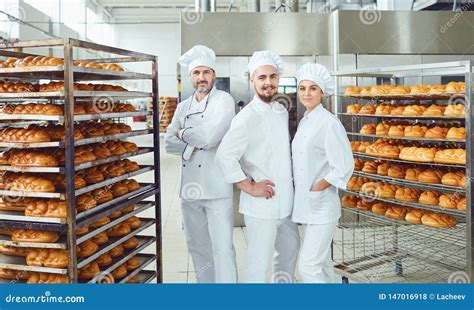 A Team of Bakers Smiles at the Bakery. Stock Photo - Image of uniform, occupation: 147016918