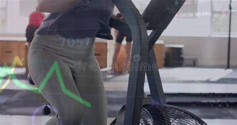 Image Of Data On Graph Over Caucasian Woman Cross Training On Elliptical At Gym Stock Image