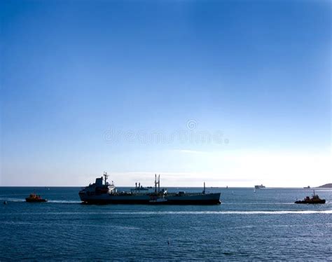 Large Cargo Ship and Tug Boats Stock Image - Image of waters, industry: 27041431