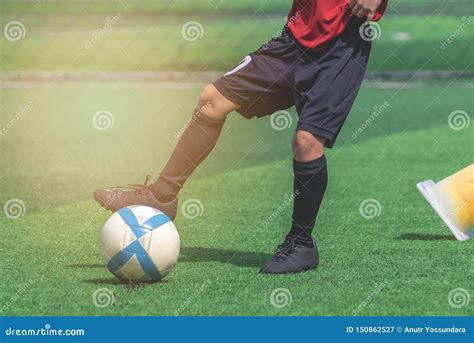 Child Feet Dribbling and Touching Soccer Ball on a Field Stock Image ...