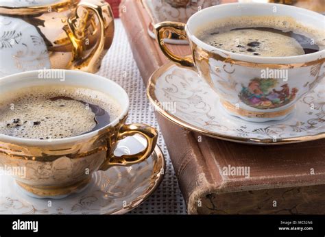 Vintage coffee break. Antique porcelain coffee cups with hot coffee ...