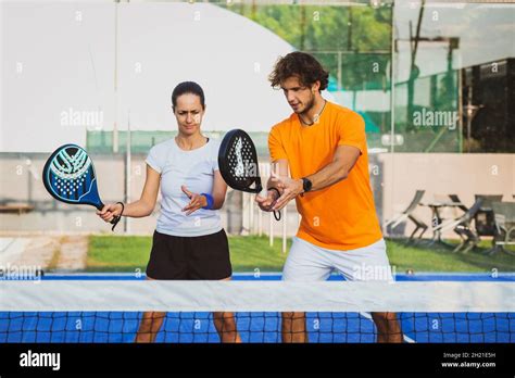 Young Teacher Is Monitoring Teaching Padel Lesson To His Student