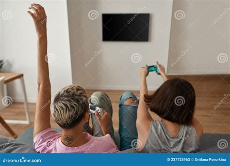 Back View Of Lesbian Girls Play Video Game On Sofa Stock Image Image