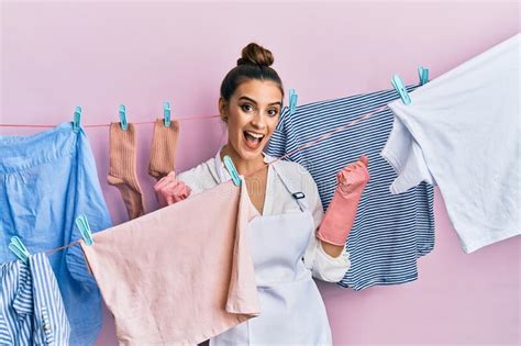 Beautiful Brunette Young Woman Washing Clothes At Clothesline