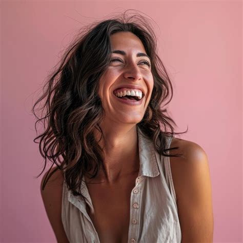 Premium Photo A Woman Laughing And Smiling In Front Of A Pink Background