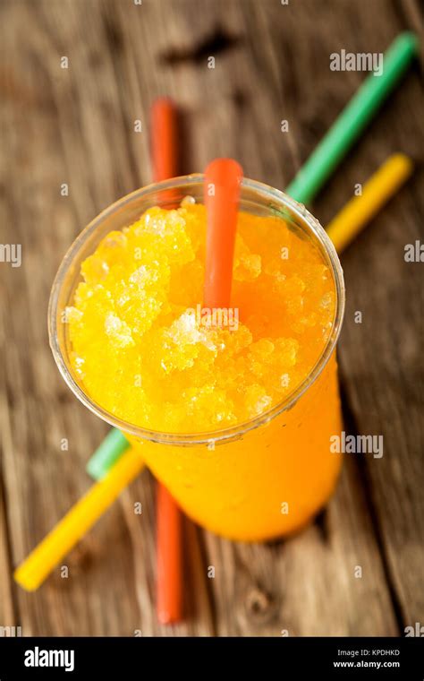 High Angle View Of Refreshing And Cool Orange Frozen Slush Drink In