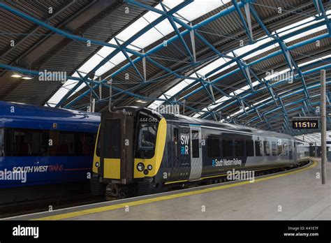 South Western Railway's first fully-liveried Class 444 train (right) arrives into the former ...