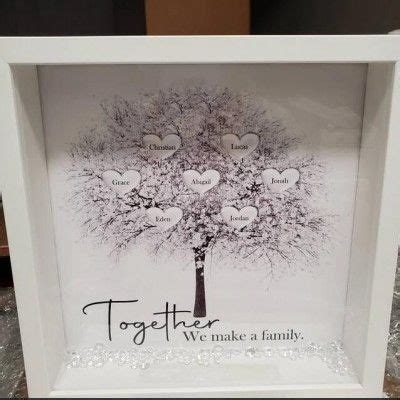 a white frame with a family tree and hearts on the inside that says ...