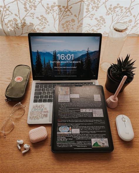 An Open Laptop Computer Sitting On Top Of A Wooden Desk Next To A Mouse