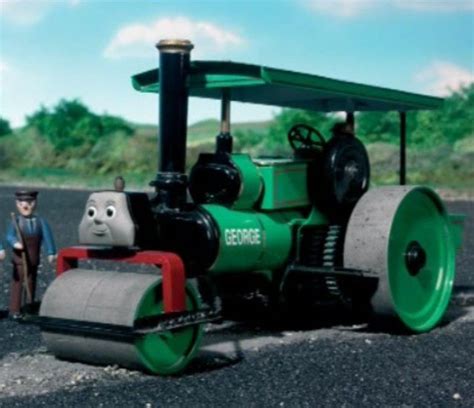 A Toy Train With Thomas The Tank Engine And Two Men Standing Next To It