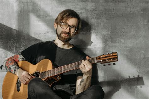 Man In Black Crew Neck T Shirt Playing Brown Acoustic Guitar · Free