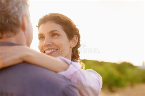 Mature Couple And Smile In Embrace At Sunset With Love Trust And